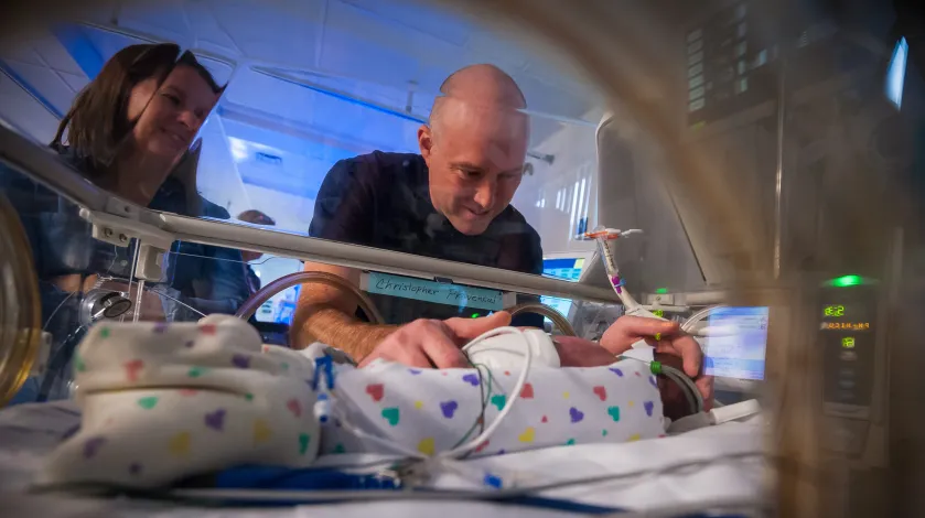 Mom and dad holding premature son